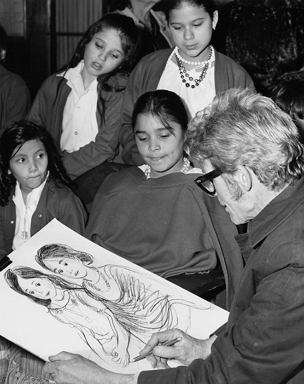Leo Politi draws a portrait of two girls while his progress is observed by other children at the library