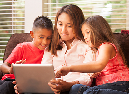 mother watching content from a tablet with her two kids