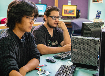 student with a laptop and headphones