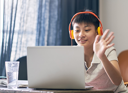 student with a laptop and headphones
